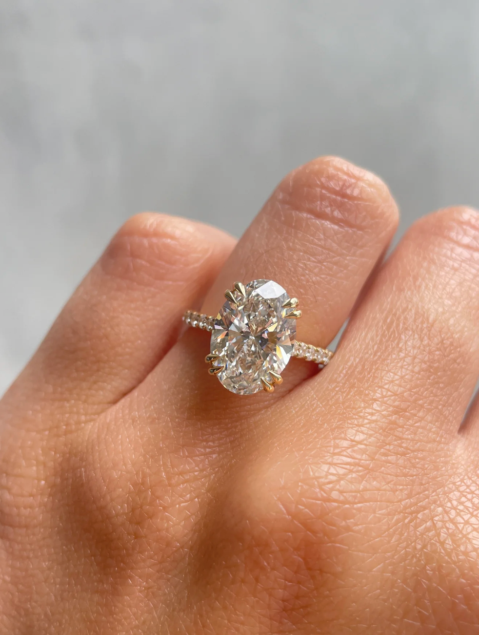 Oval Solitaire with Double Tipped Claws and Pavé Band